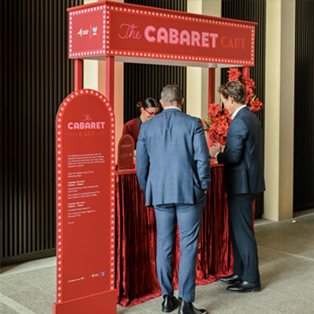 People standing at a promotional kiosk at Festival Tower