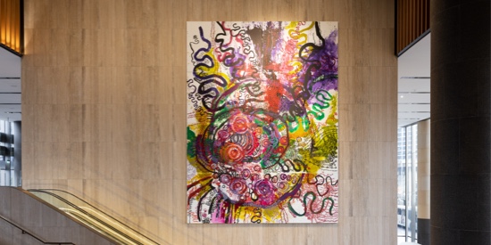 A view of vibrant abstract painting displayed on a wall.